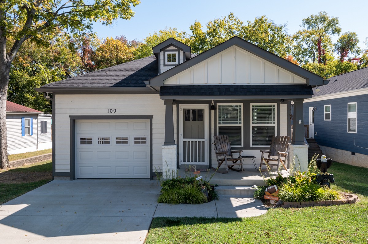 a front view of a house with a yard and garage