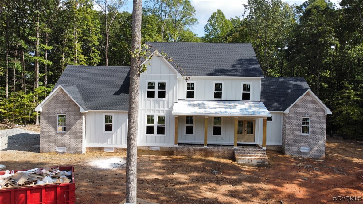 Modern inspired farmhouse featuring covered porch