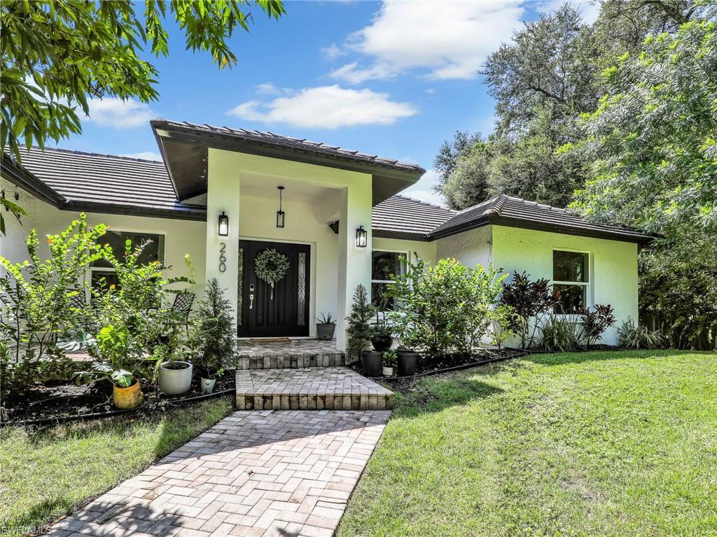 a front view of a house with garden