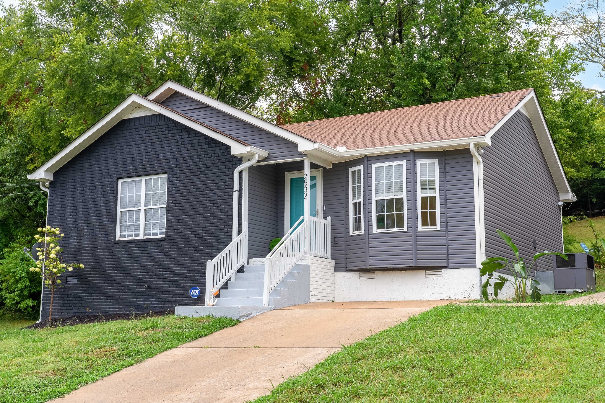 a front view of a house with a yard