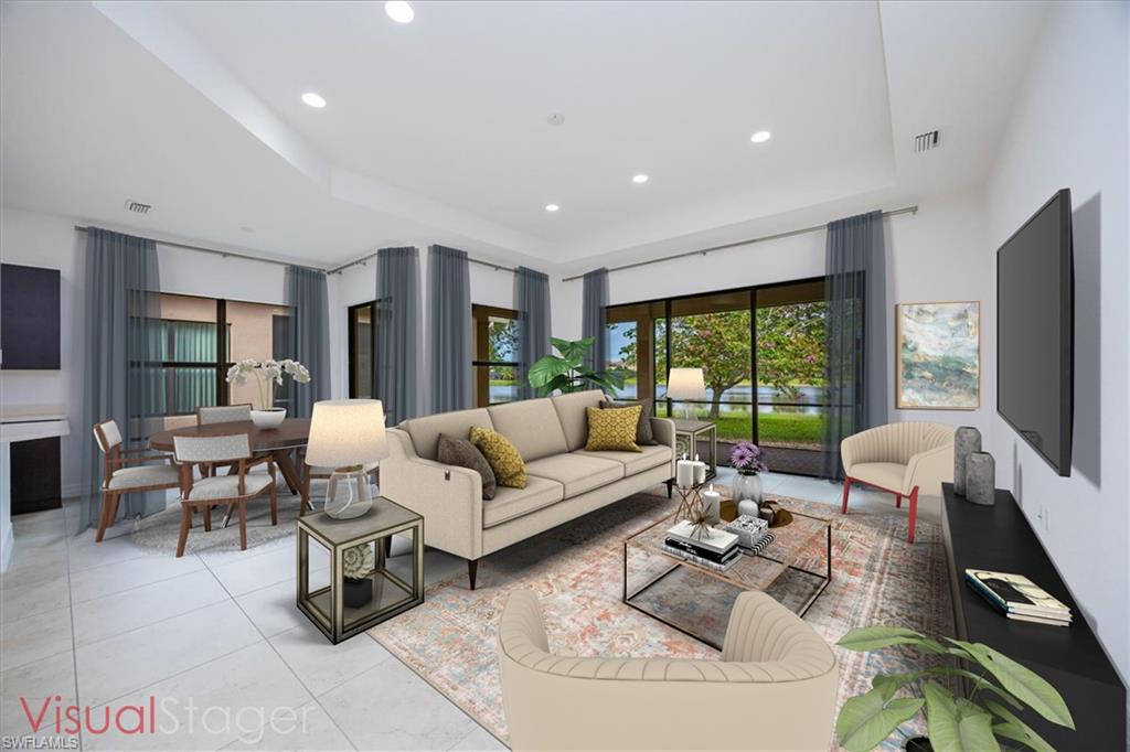 Living room with light tile patterned flooring and a tray ceiling