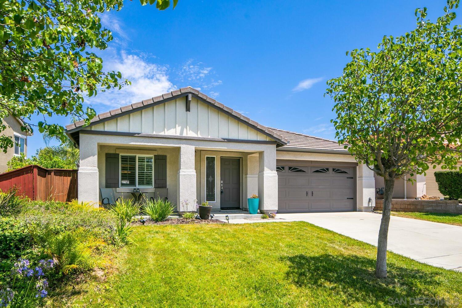 a view of a house with yard and tree s