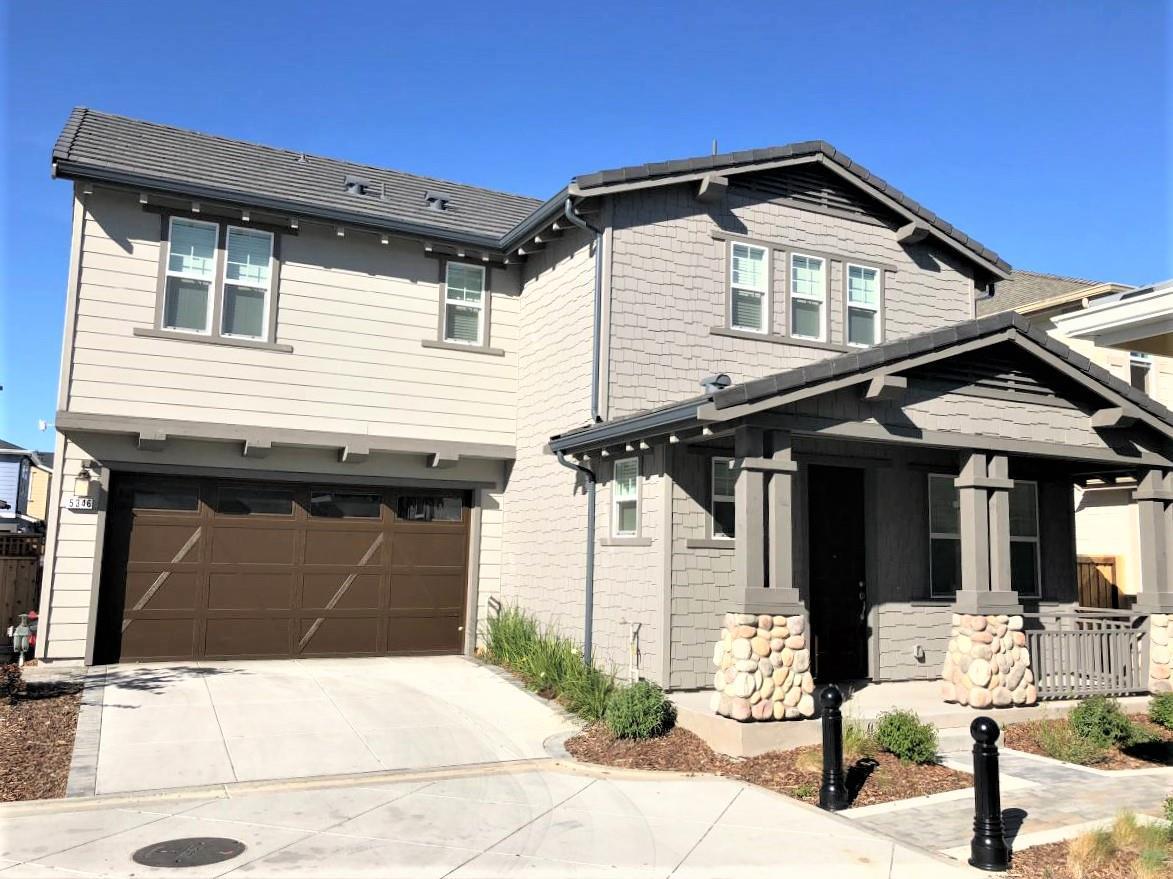 a front view of a house with a parking area