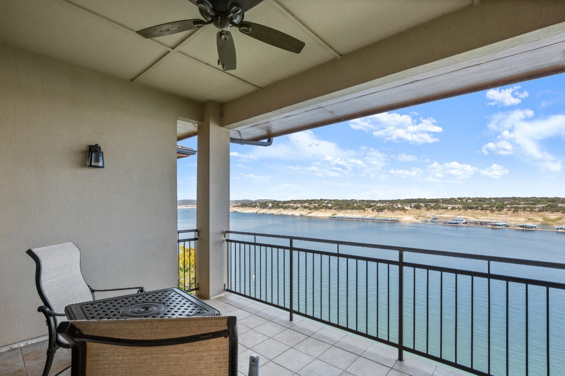 a view of a chairs and table in the balcony