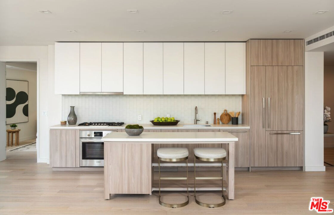 a kitchen with a stove and a white cabinets