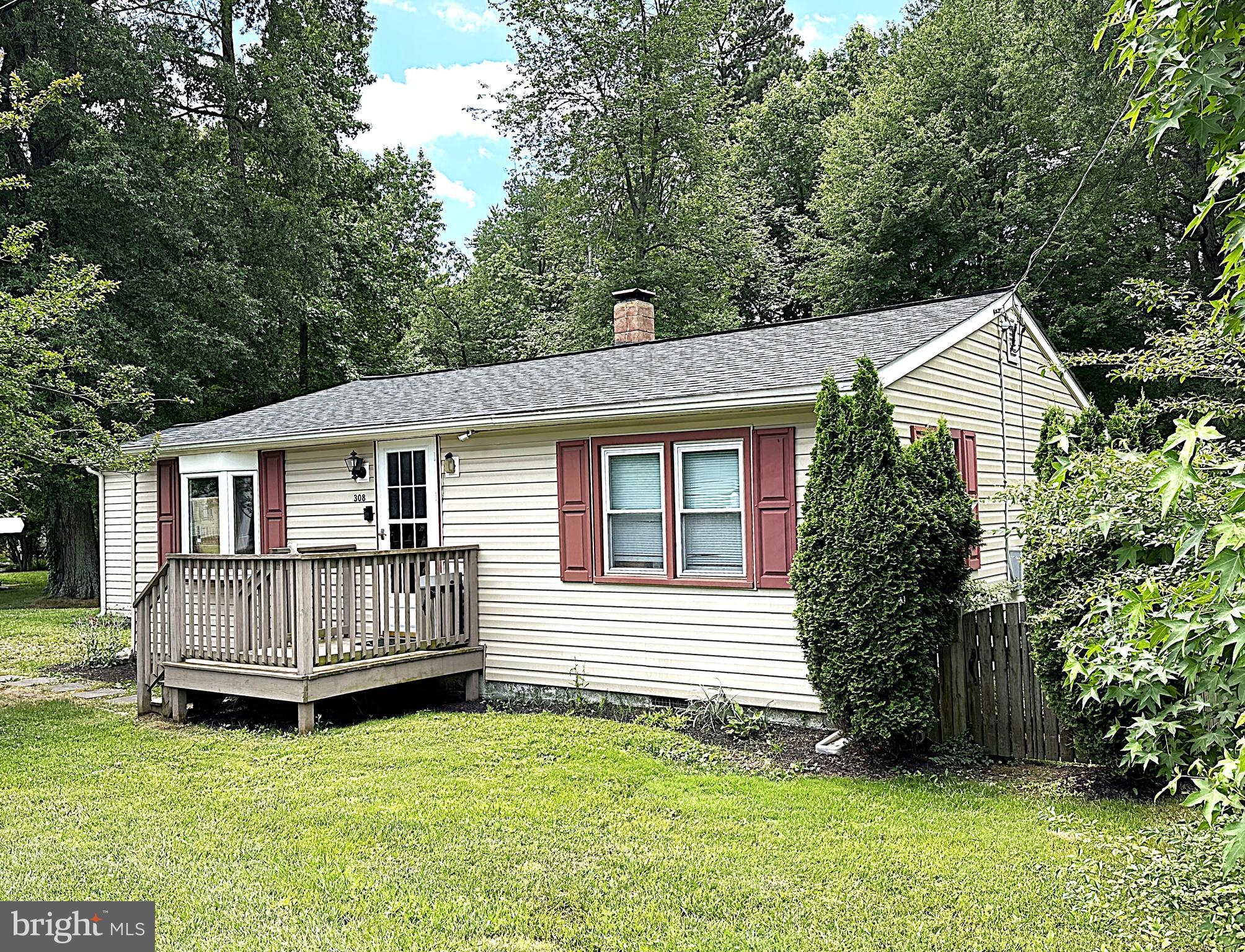 a view of a house with a yard and deck