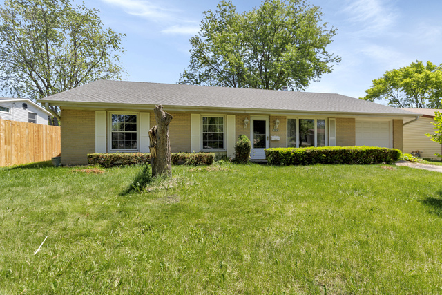 a front view of house with yard and green space