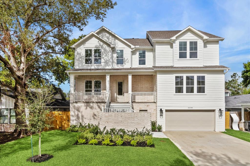 a front view of a house with a garden and yard