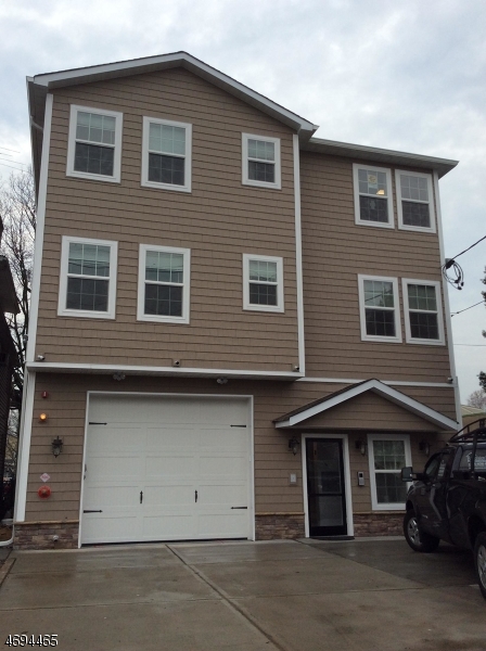 a front view of a house with parking space