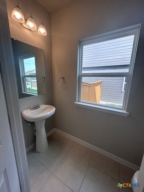 a bathroom with a sink toilet and a mirror