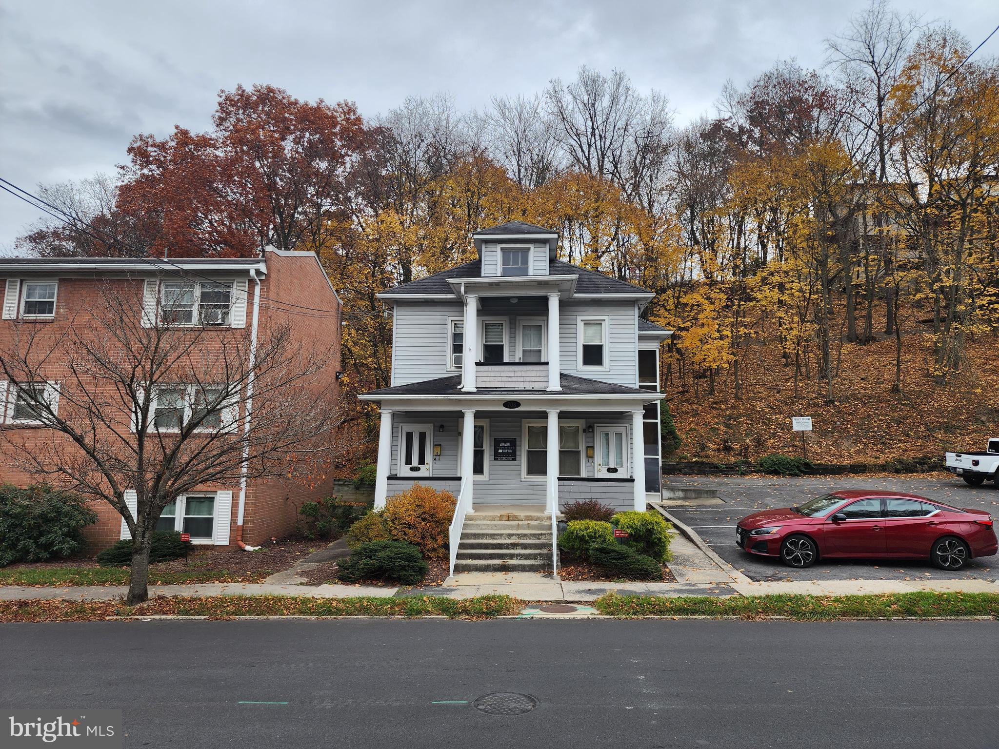 a house that has a tree in front of it