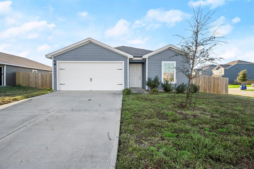 a view of a front of house with a yard and garage