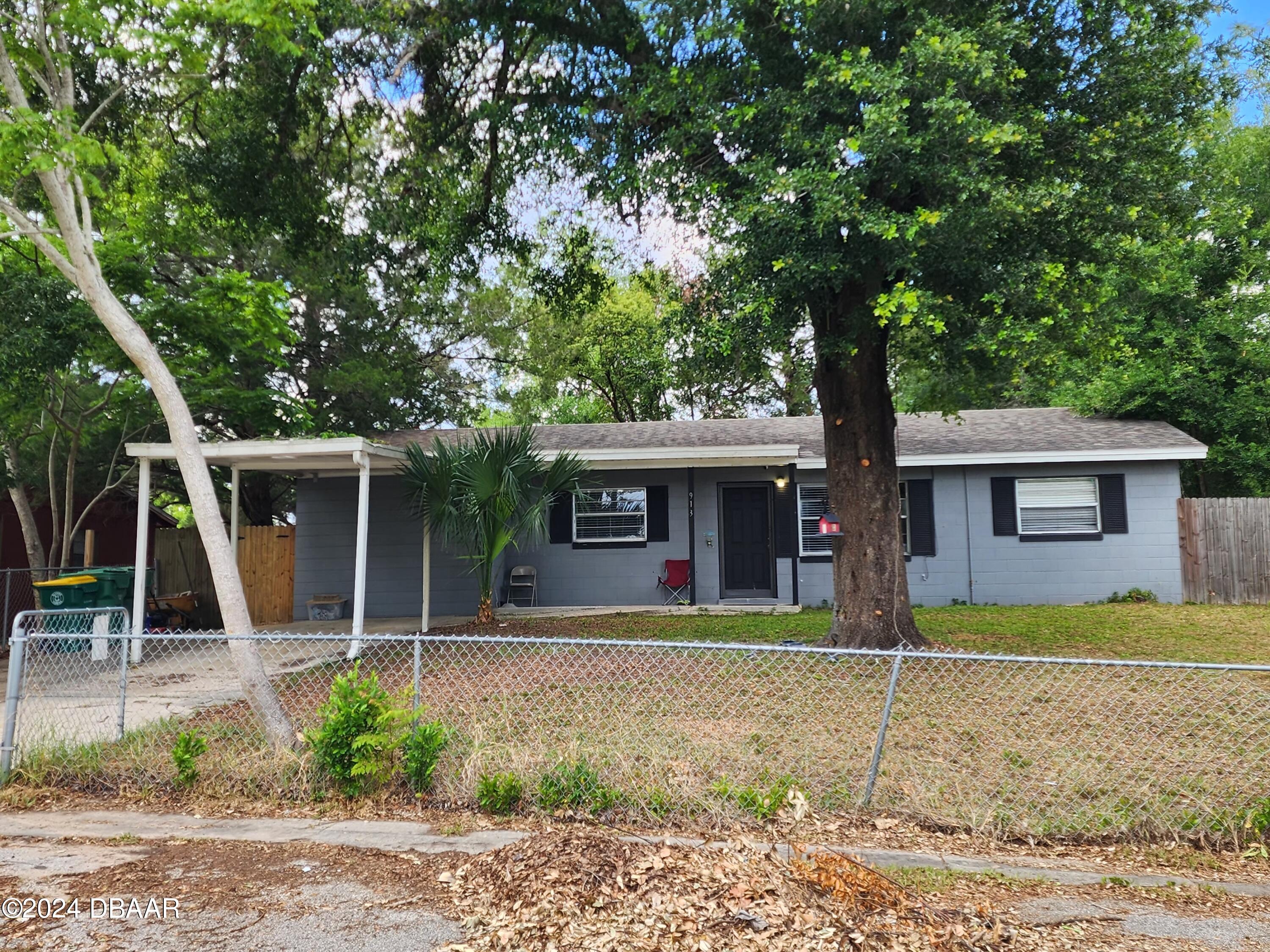 a house that has a tree in front of it