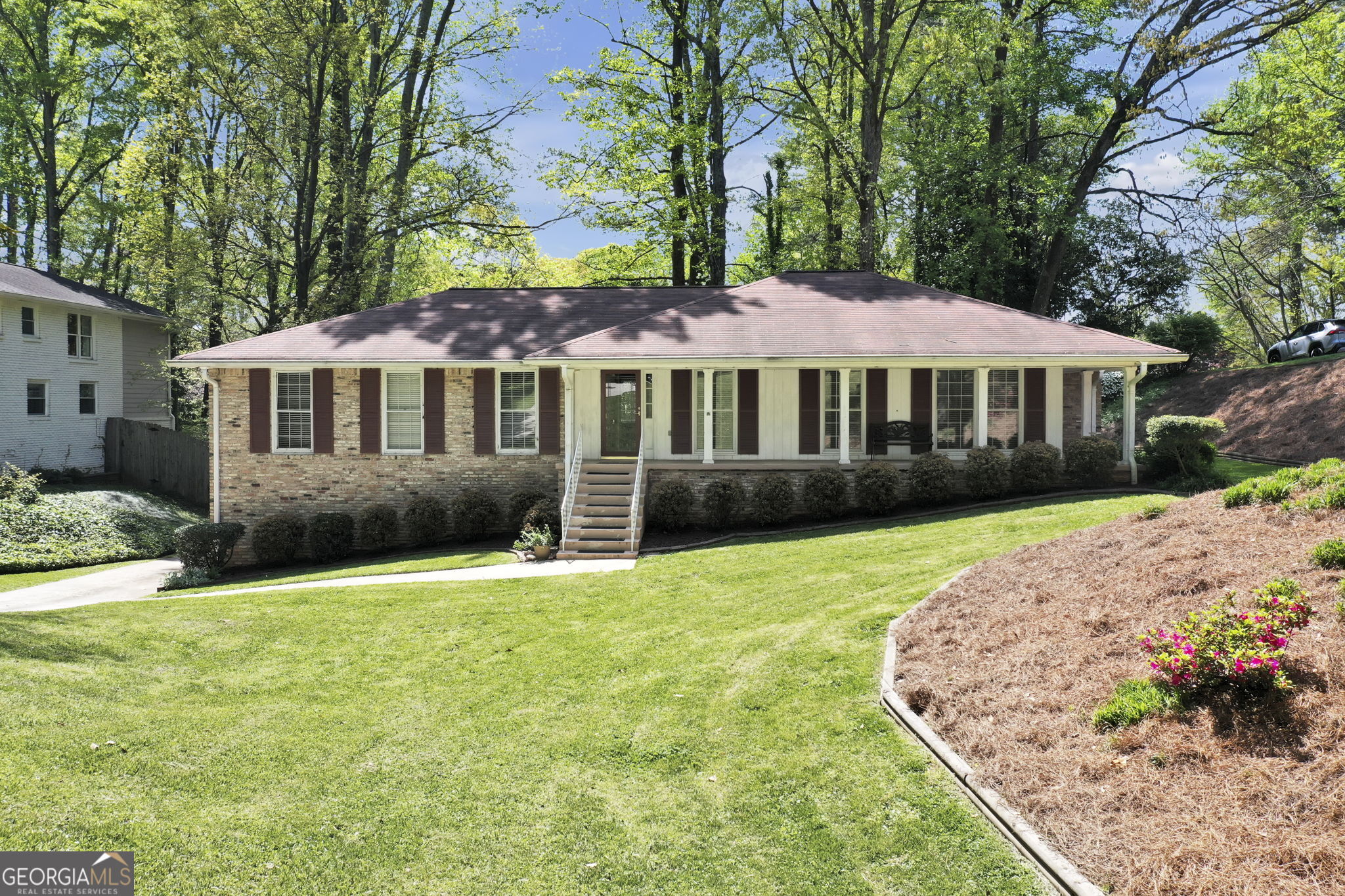 a front view of a house with a garden