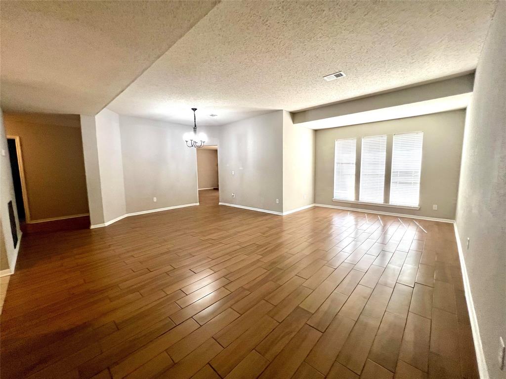 A picturesque view of the living room and dining room flowing seamlessly into the family room, creating an open and inviting atmosphere. This layout is perfect for entertaining and family gatherings!