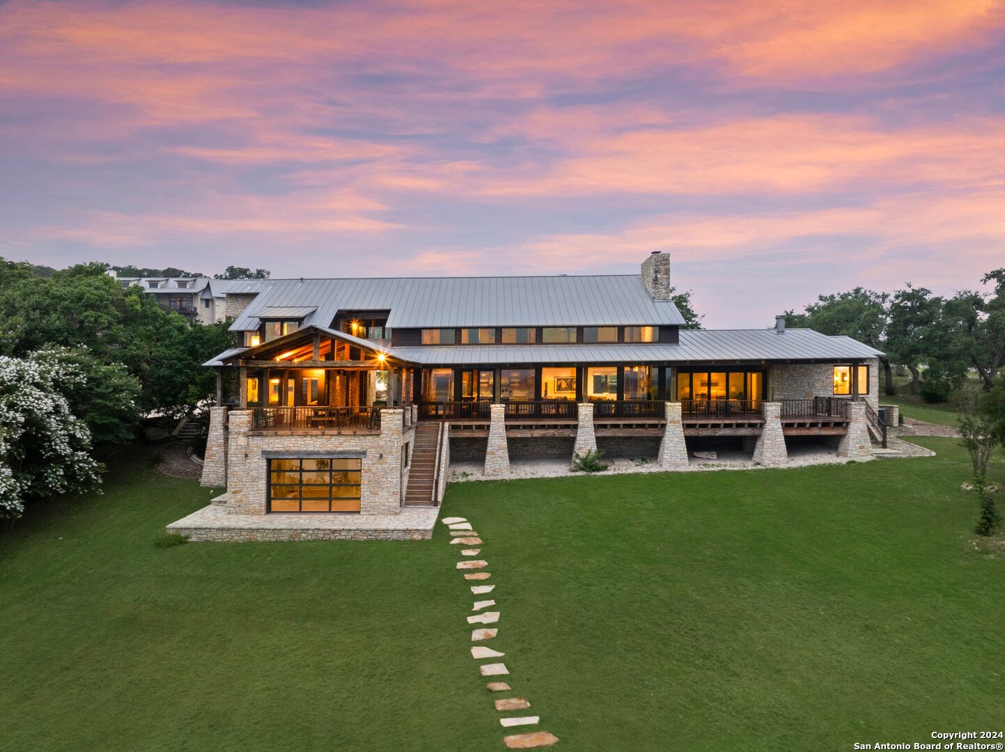 an aerial view of a house with a big yard