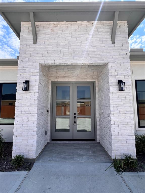 A building's entrance showcasing two doors, providing access to the interior and welcoming guests.