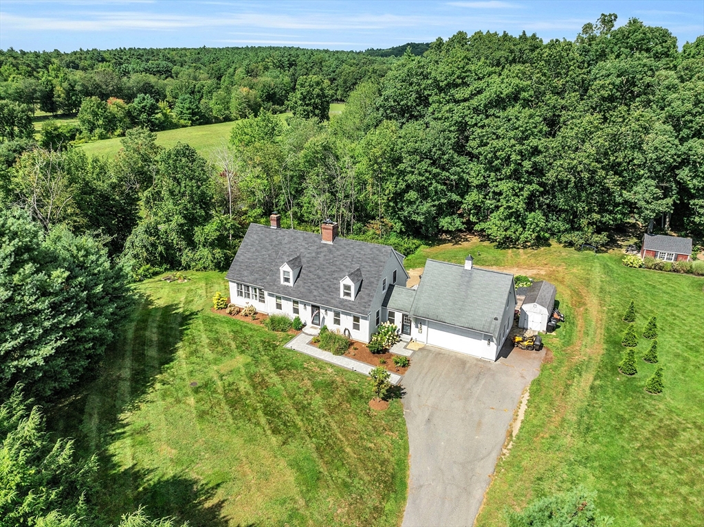 an aerial view of a house with a yard