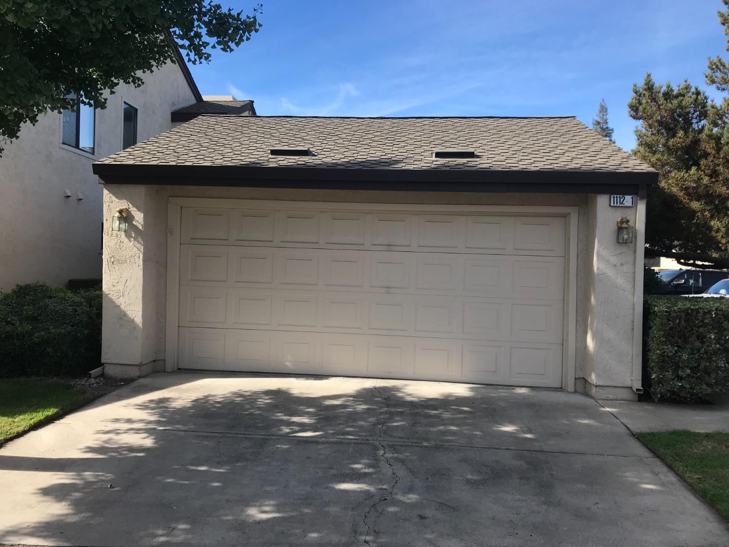 a view of a stone house with a garage