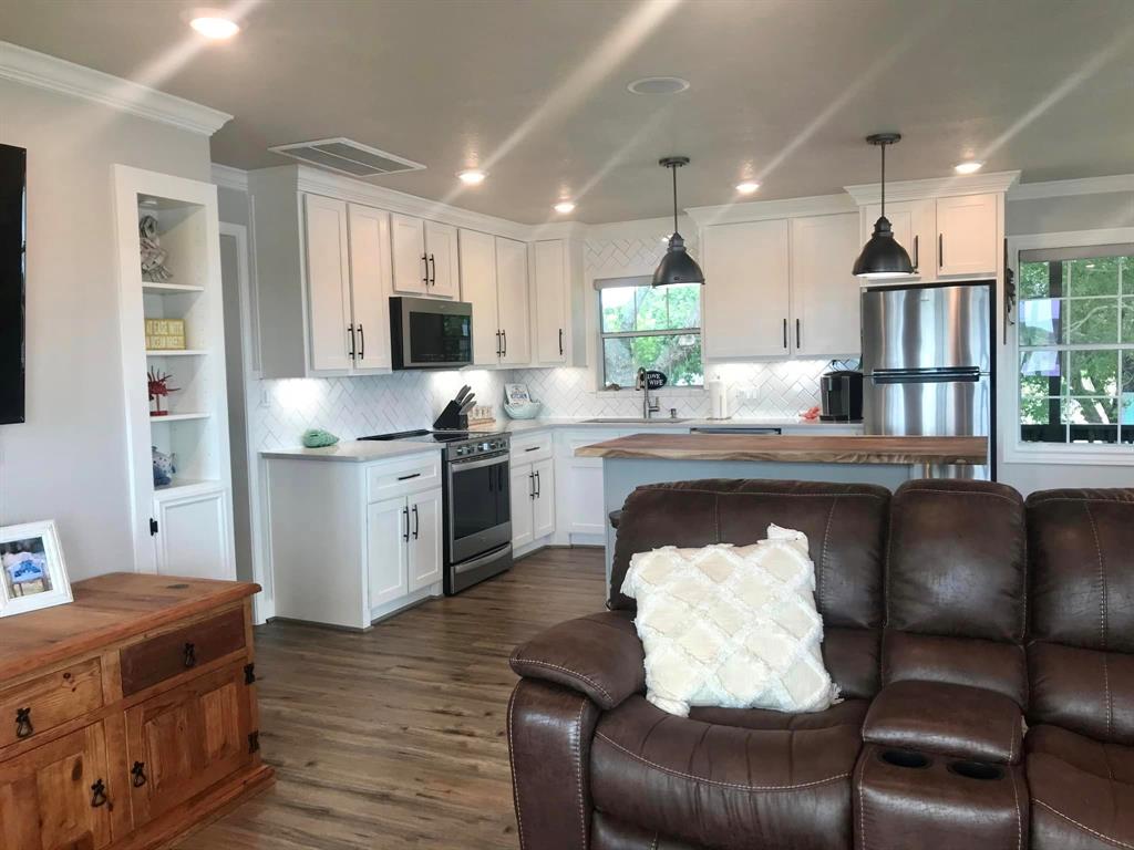 a kitchen with a table chairs stove and cabinets