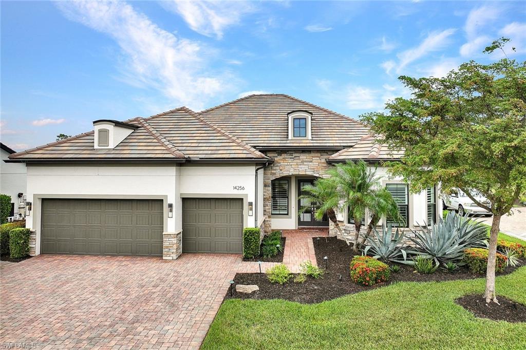 Single family home featuring a 3-car garage and a front lawn