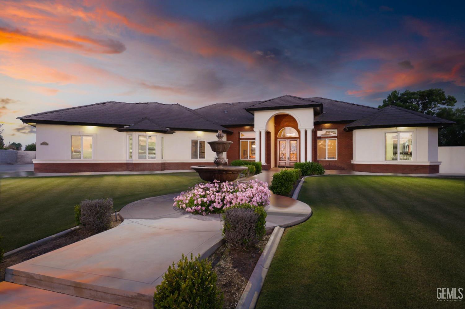 a front view of a house with a garden