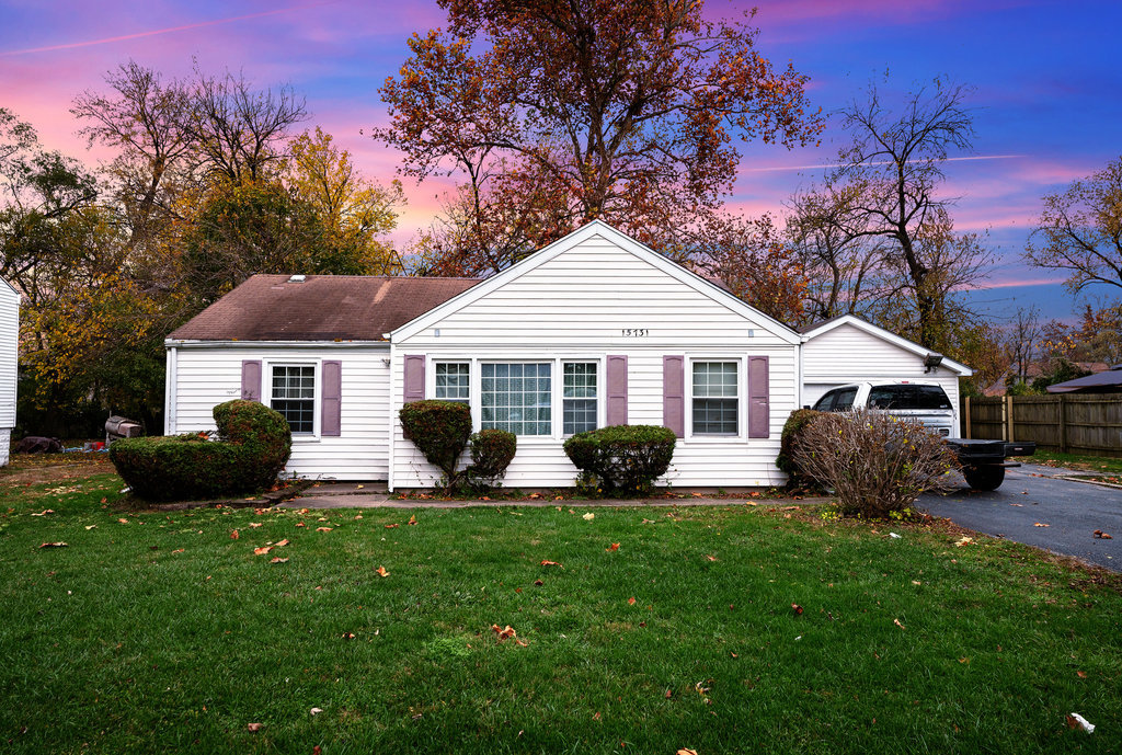 a front view of house with yard and outdoor seating