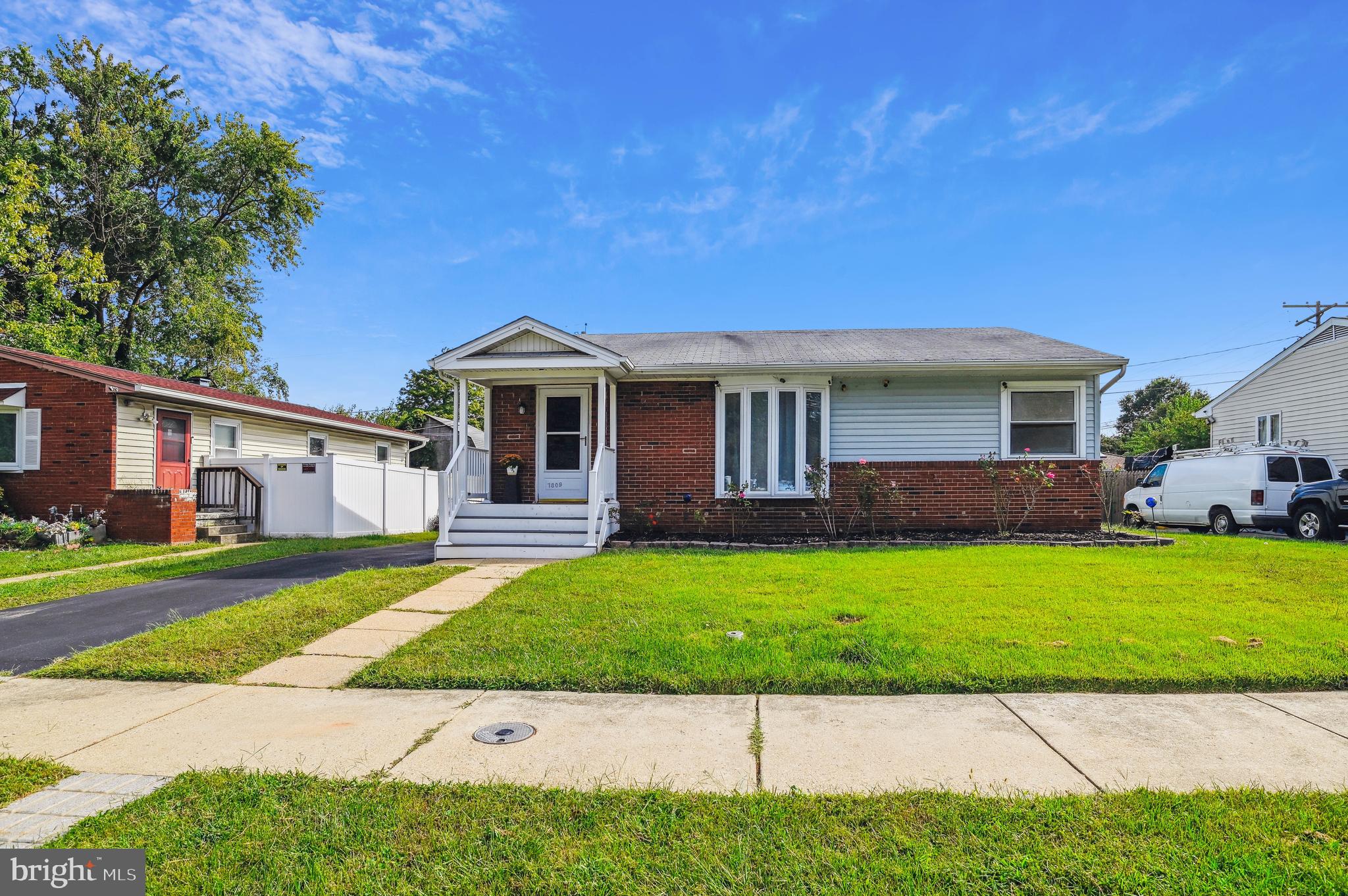 a front view of a house with a yard and porch