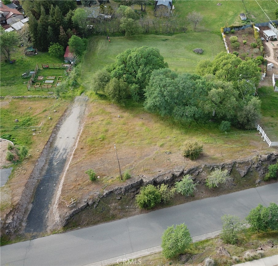 an aerial view of a house with a yard and lake view