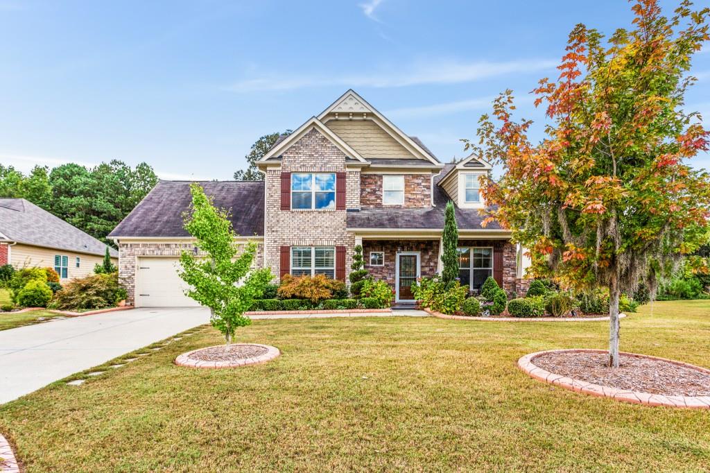 a front view of a house with a yard