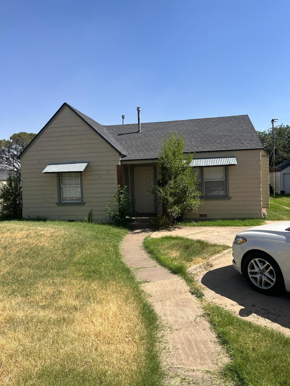 a front view of a house with parking space