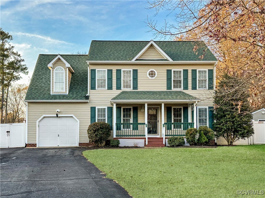 Colonial house feat coveredporch, a front yard, an