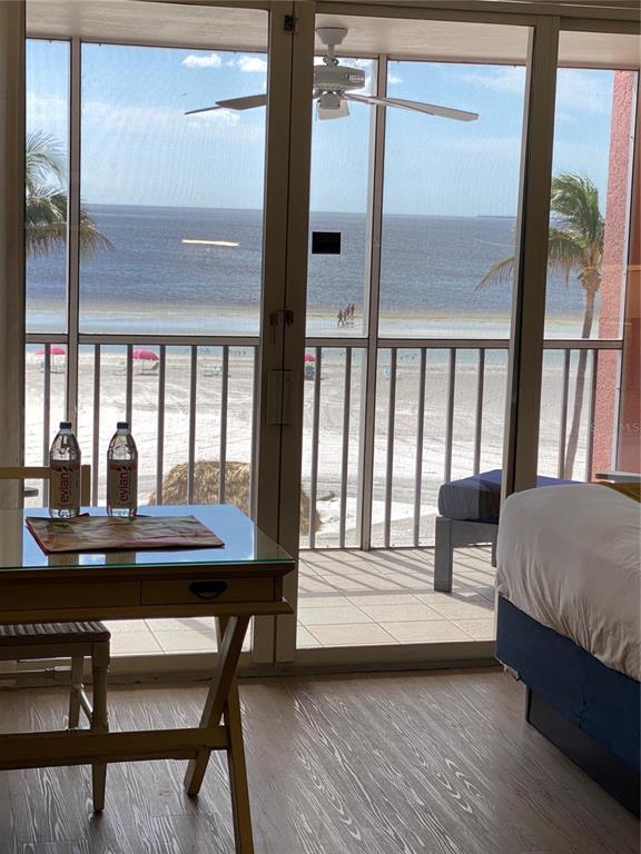 a bedroom with a bed and a large window with balcony view