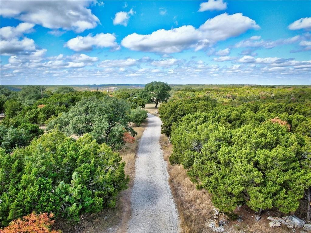 a view of a pathway both side of a yard