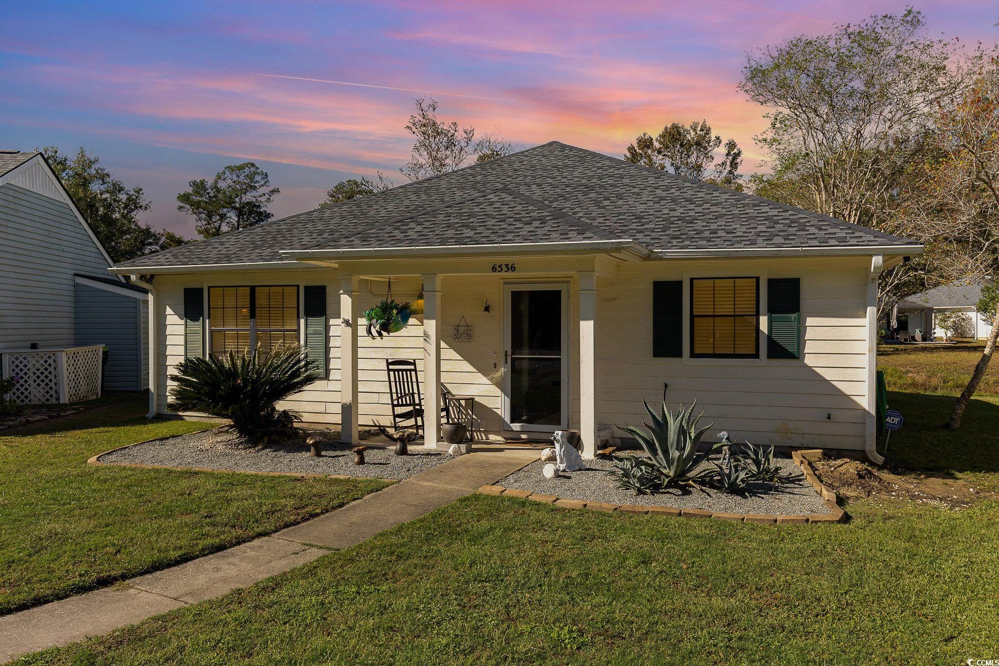 Bungalow-style house with a lawn