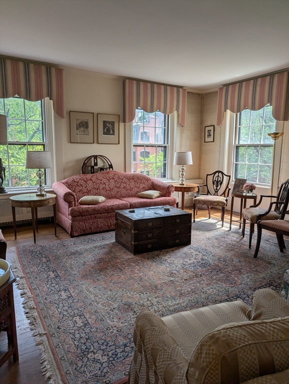 a living room with furniture large window and a table