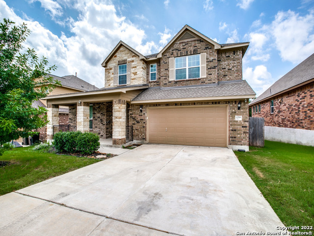 a front view of a house with a yard and garage