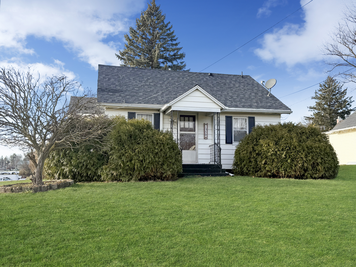 a front view of a house with a garden