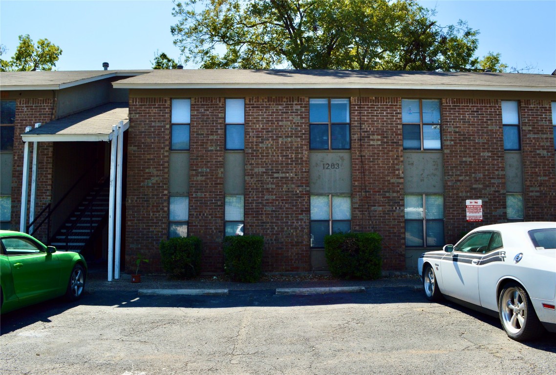 a car parked in front of a brick house