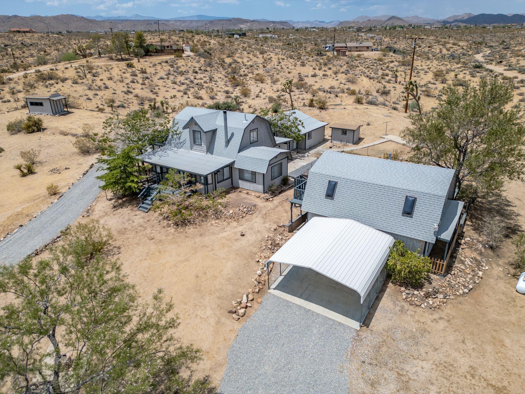 an aerial view of a house with a yard and wooden fence