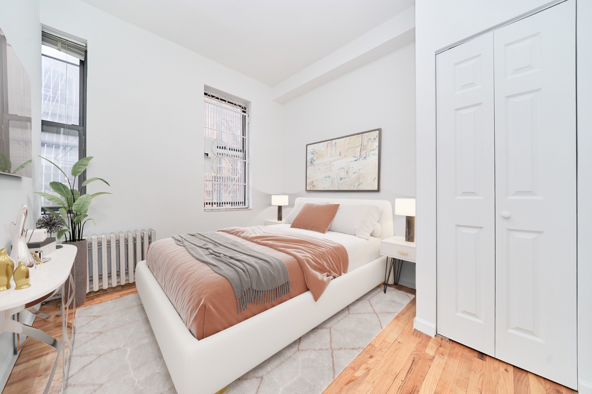 a bedroom with a bed and a potted plant