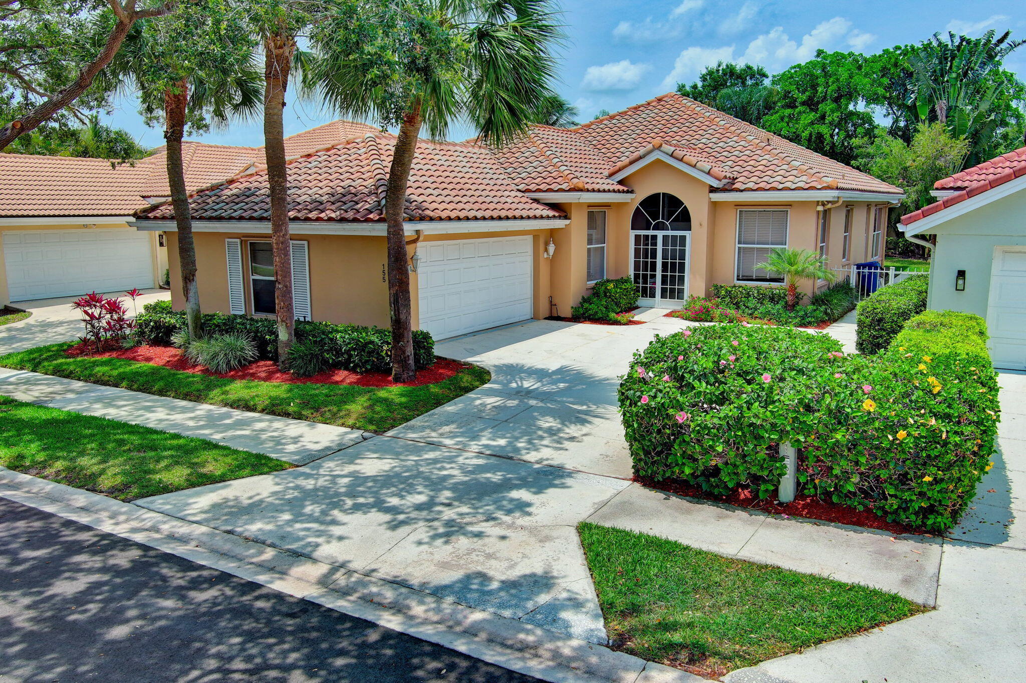 a front view of a house with a garden