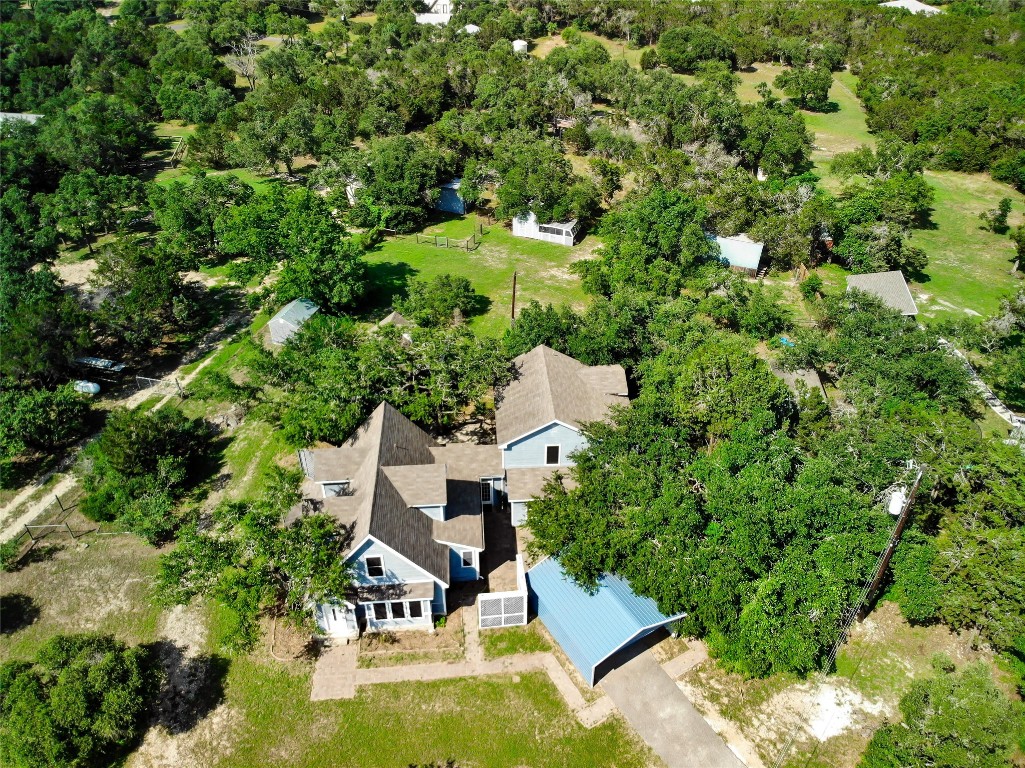 an aerial view of a house with swimming pool and garden