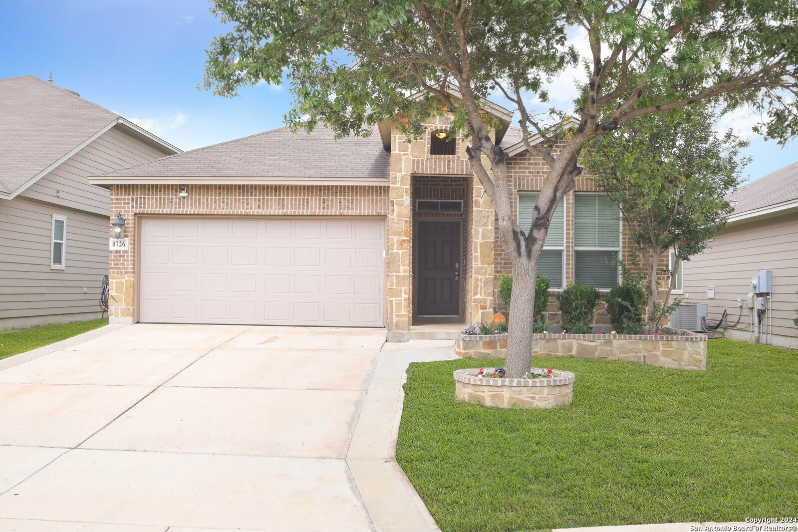 a front view of a house with a yard and garage