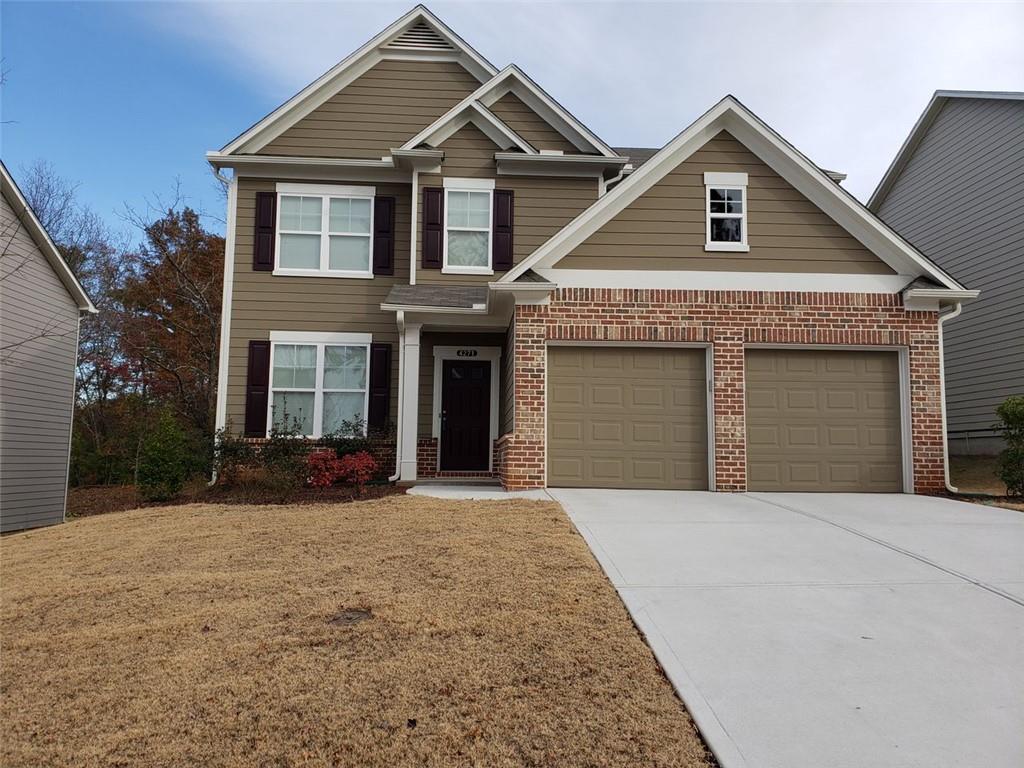 a front view of a house with a yard and garage