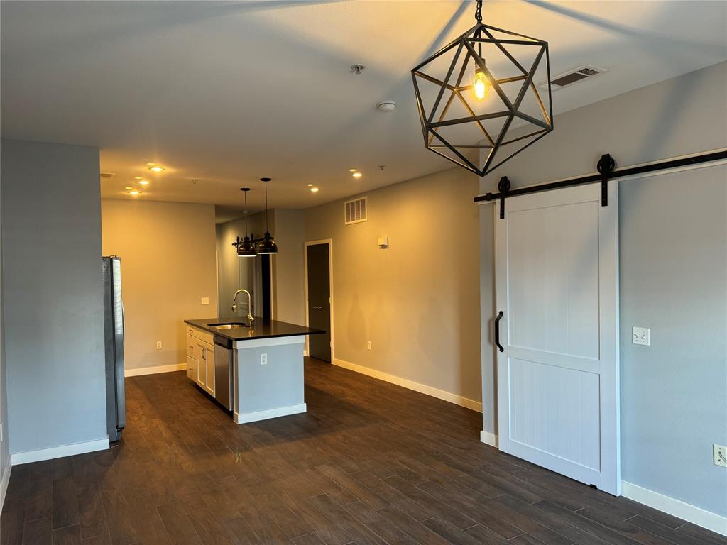 a view of a room with wooden floor and ceiling fan