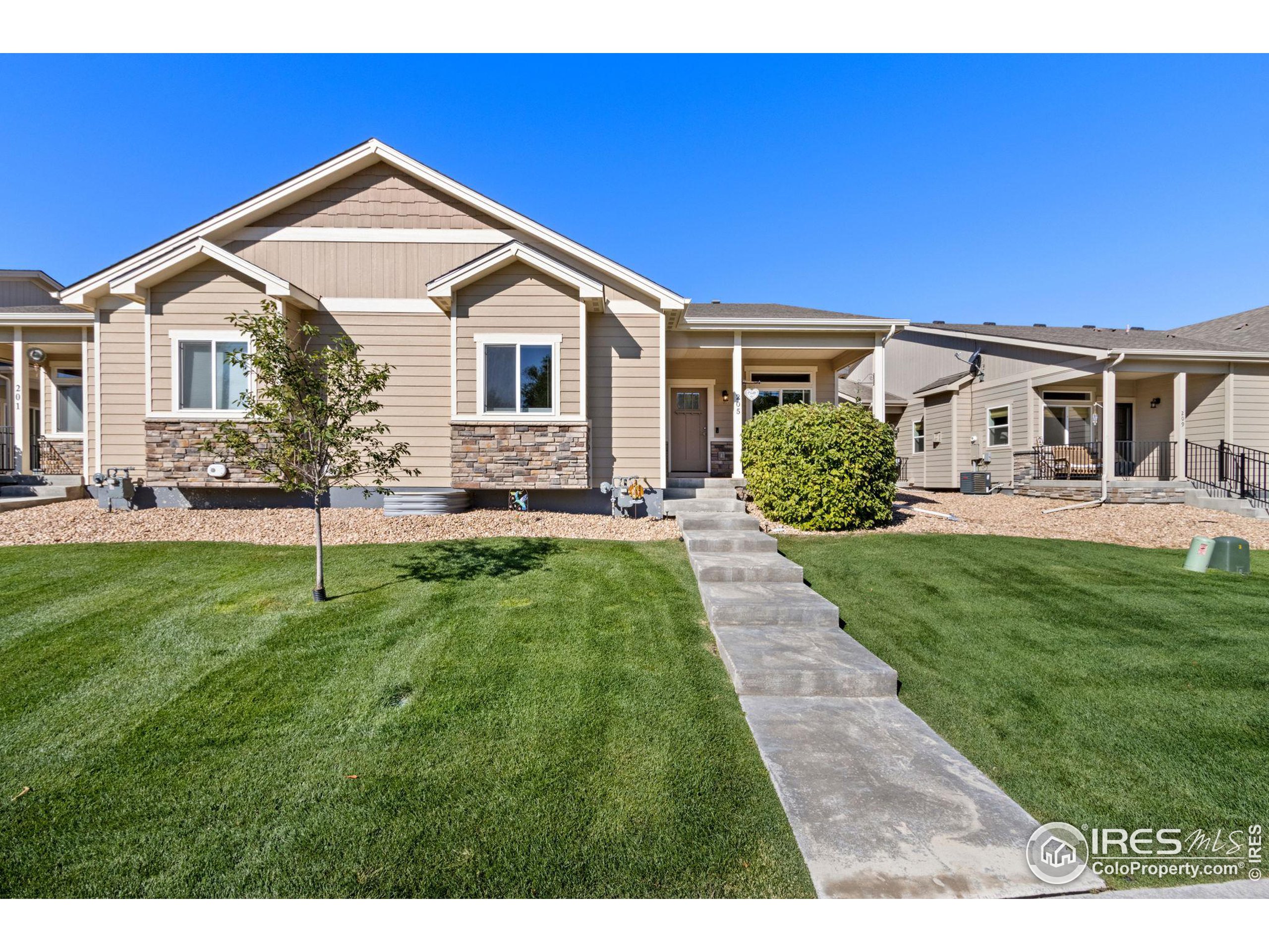 a front view of a house with a yard and outdoor seating