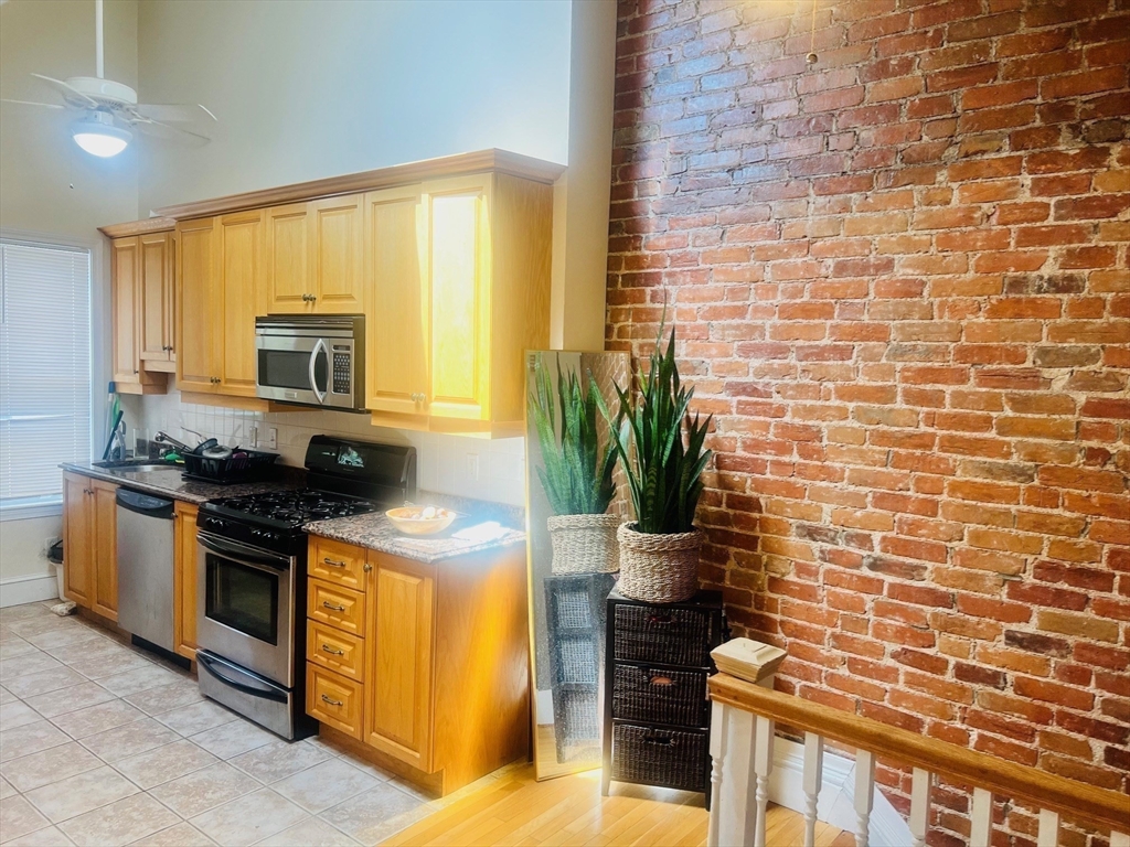 a kitchen with stainless steel appliances a stove a sink and a microwave