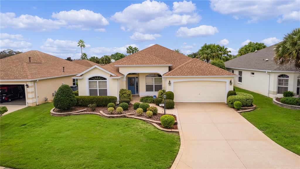 a front view of a house with a yard and garage