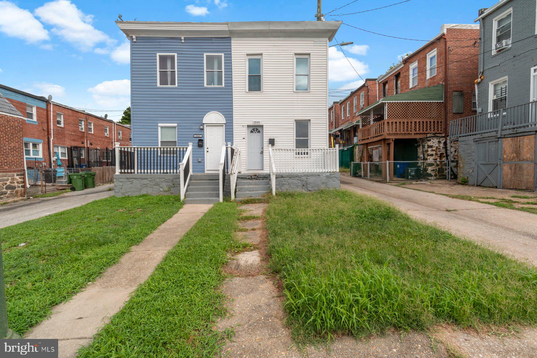 a front view of a building with a yard